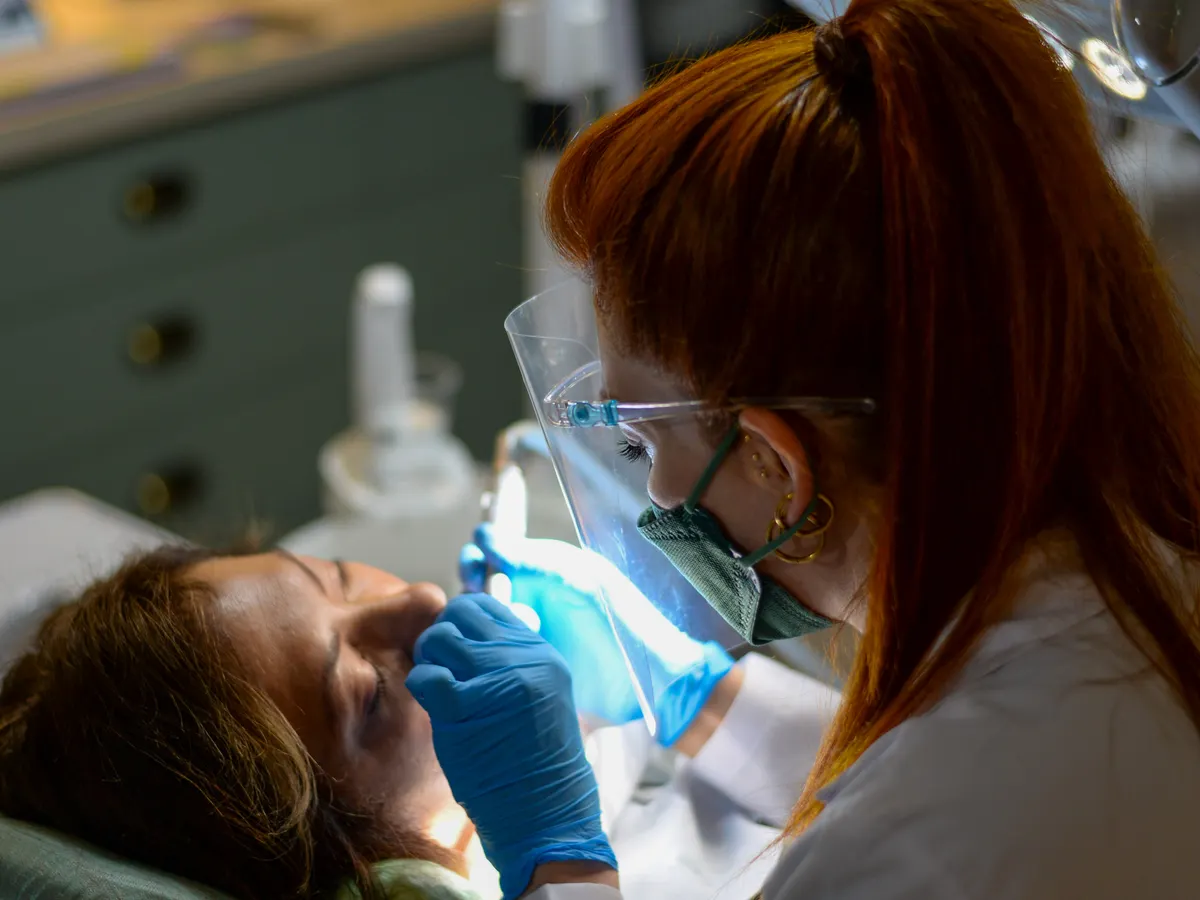 A dentist examining a relaxed patient in a modern clinic